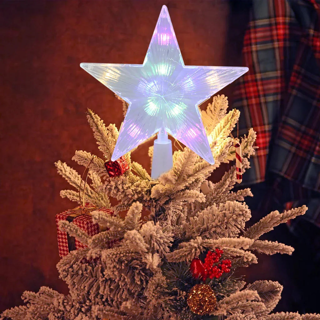 Decorative star light on a Christmas tree with a plaid fabric background