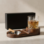 Wooden tray with glass of whiskey and ashtray on a neutral background