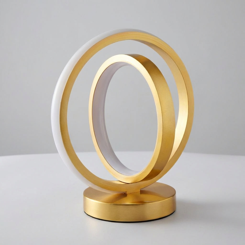 Gold and white circular table lamp on a light gray background