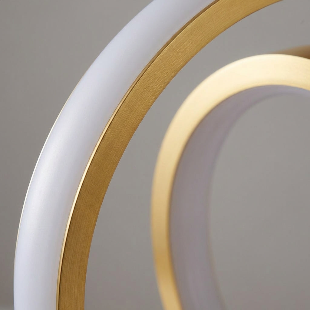 Close-up of a modern lamp with gold and white circular design on a gray background