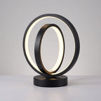 Modern table lamp with two interlocking circular designs on a gray background