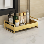 Gold tray with skincare products on a marble surface