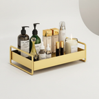 Gold tray with various skincare products on a light background