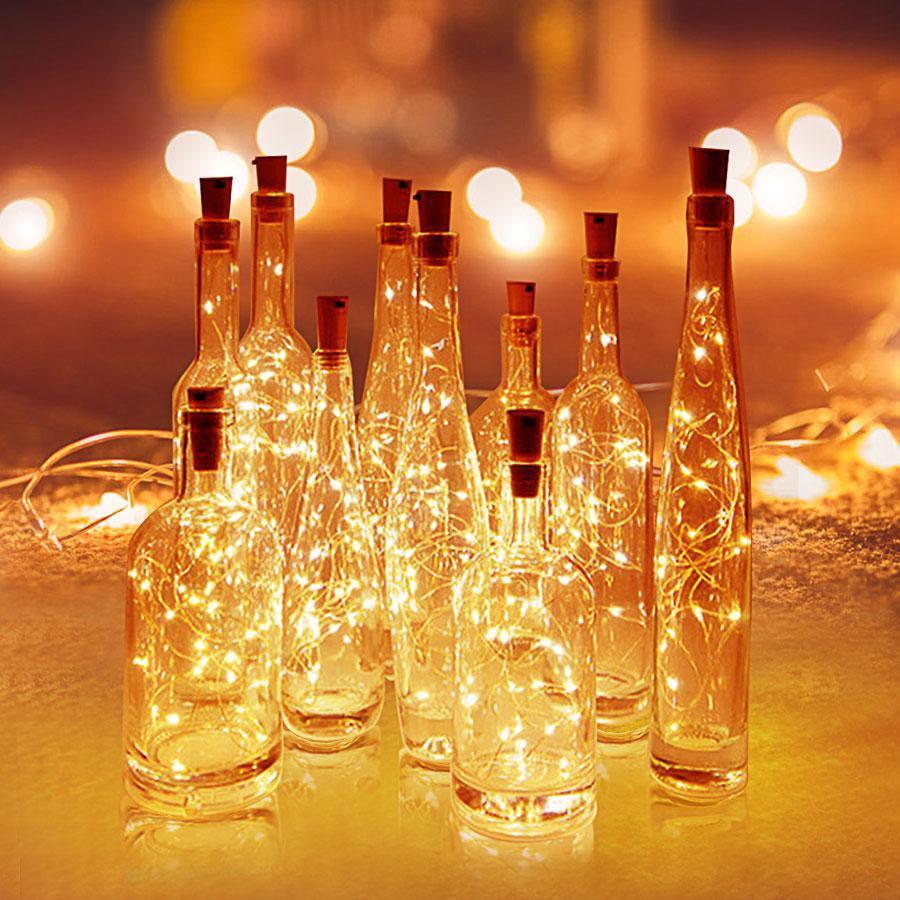 Decorative glass bottles with string lights against a warm, blurred background