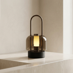 Modern table lamp with a smoked glass shade on a neutral background