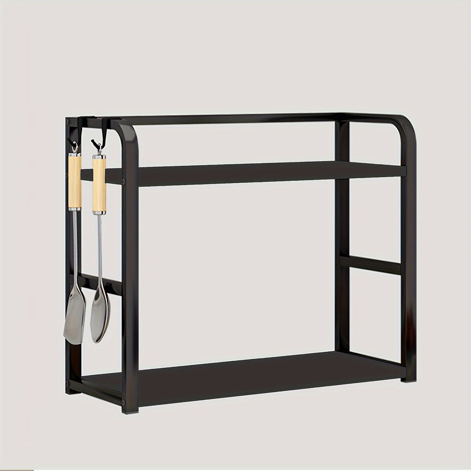 Black metal shelf with utensils on a light gray background