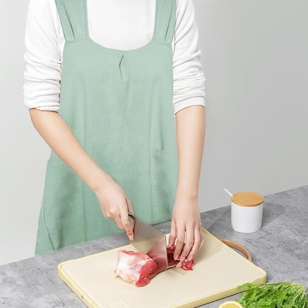 Person cutting meat on a wooden board with a white background
