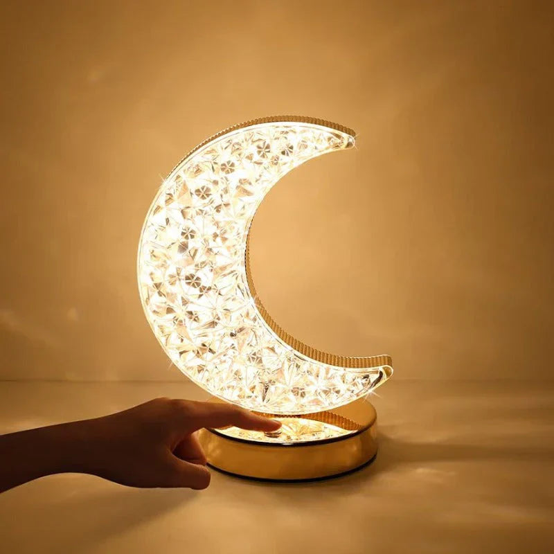 Decorative moon-shaped lamp with floral patterns on a warm beige background