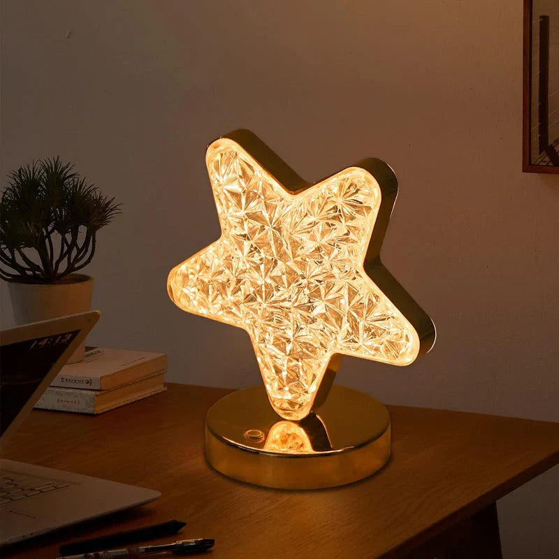 Star-shaped table lamp on a desk with a warm glow
