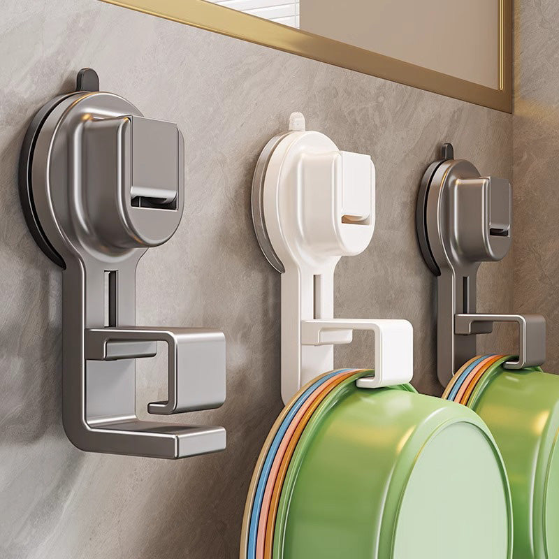 Wall-mounted hooks with colorful containers on a tiled wall.