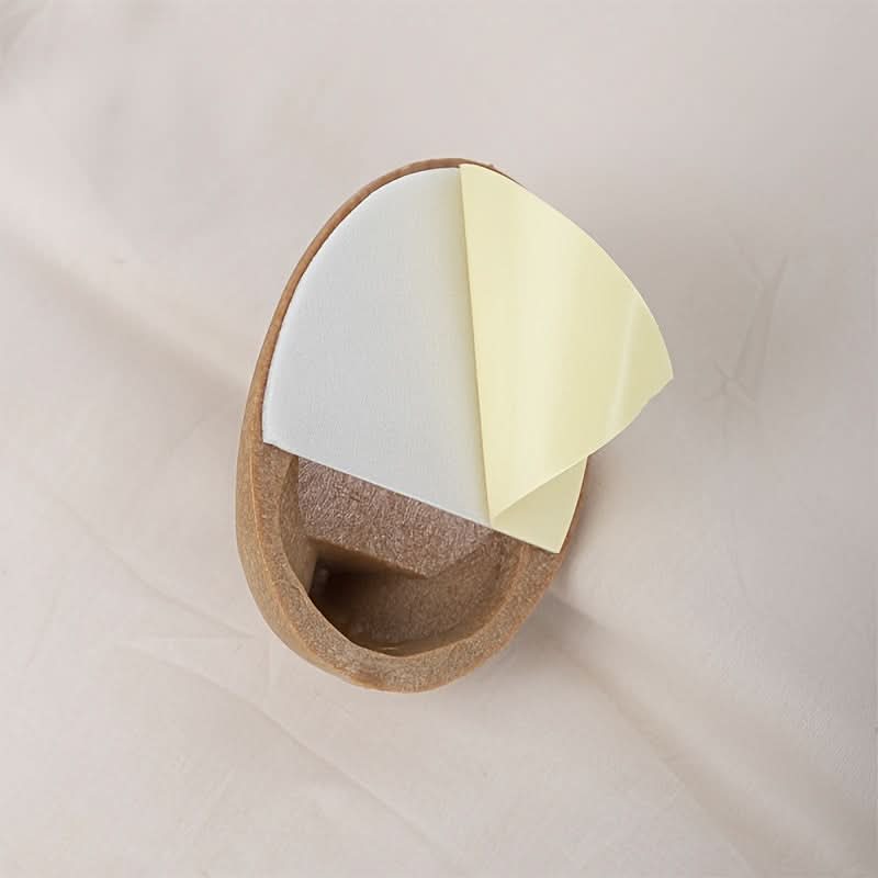 Wooden holder with two sticky notes, one white and one yellow, on a light background