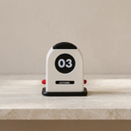 Small calendar with '03' on a shelf against a beige wall