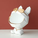 White and gold decorative item resembling a dog with sunglasses on a red background