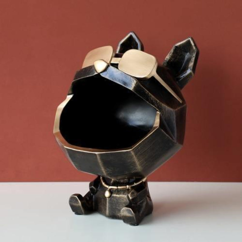 Black and gold geometric dog figurine on a white surface with a red background