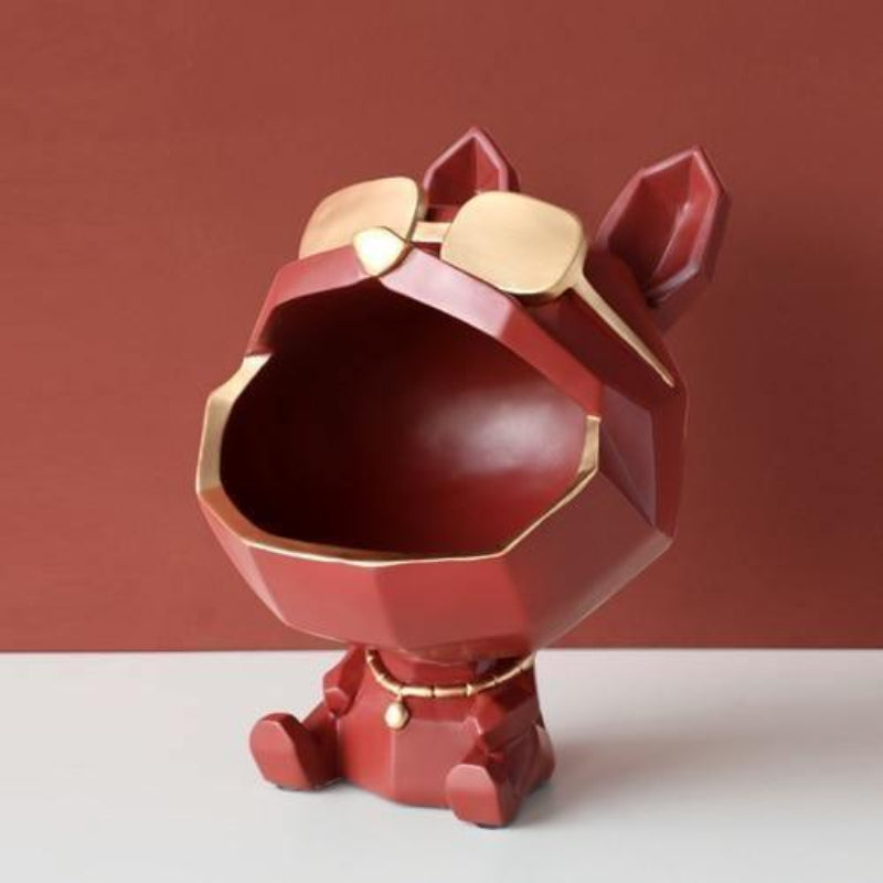 Red and gold dog-shaped decorative item on a white surface with a red background