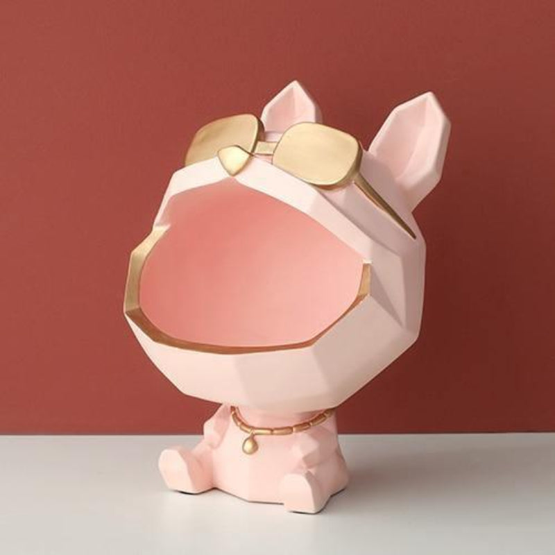 Pink and gold decorative item resembling a dog with sunglasses on a red background