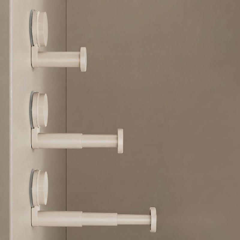 Three white plastic door stoppers with circular suction cups mounted on a beige door, shown against a matching beige background.