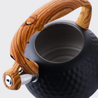 Teapot with wooden handle and trim on a light gray background