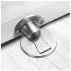 Metallic door stopper on a wooden floor