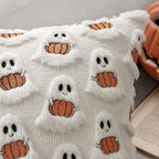 White blanket with ghost and pumpkin pattern on a gray surface