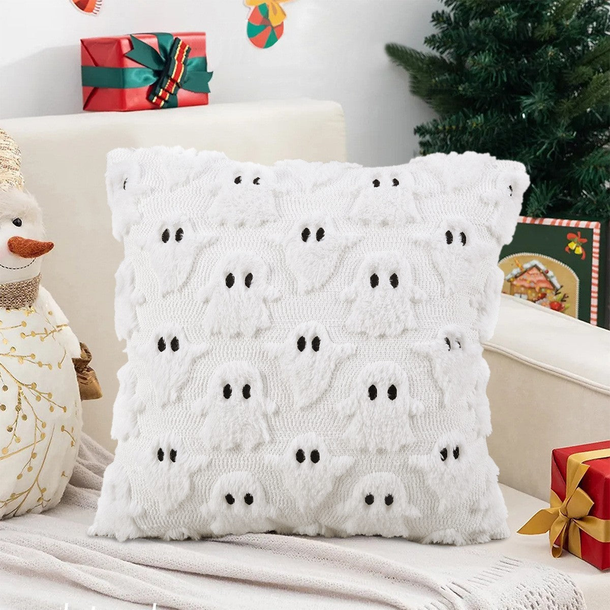 White knitted pillow with black details on a festive background with Christmas decorations.