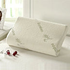 Bamboo pillow on a bed with a window in the background