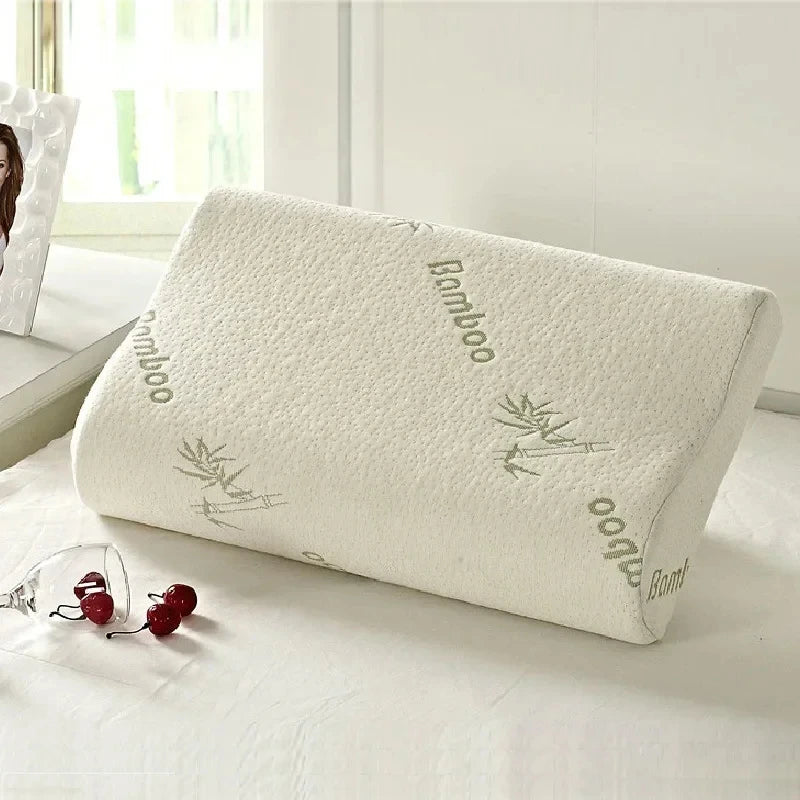 Bamboo pillow on a bed with a window in the background