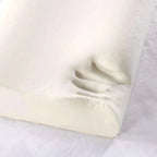 Close-up of a white fitted sheet on a bed