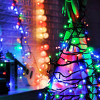 Decorative string lights on a tree with a blurred colorful background