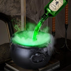 Green liquid being poured into a cauldron with a Halloween-themed bottle in the background.