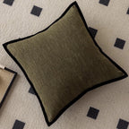 Brown textured pillow on a patterned rug