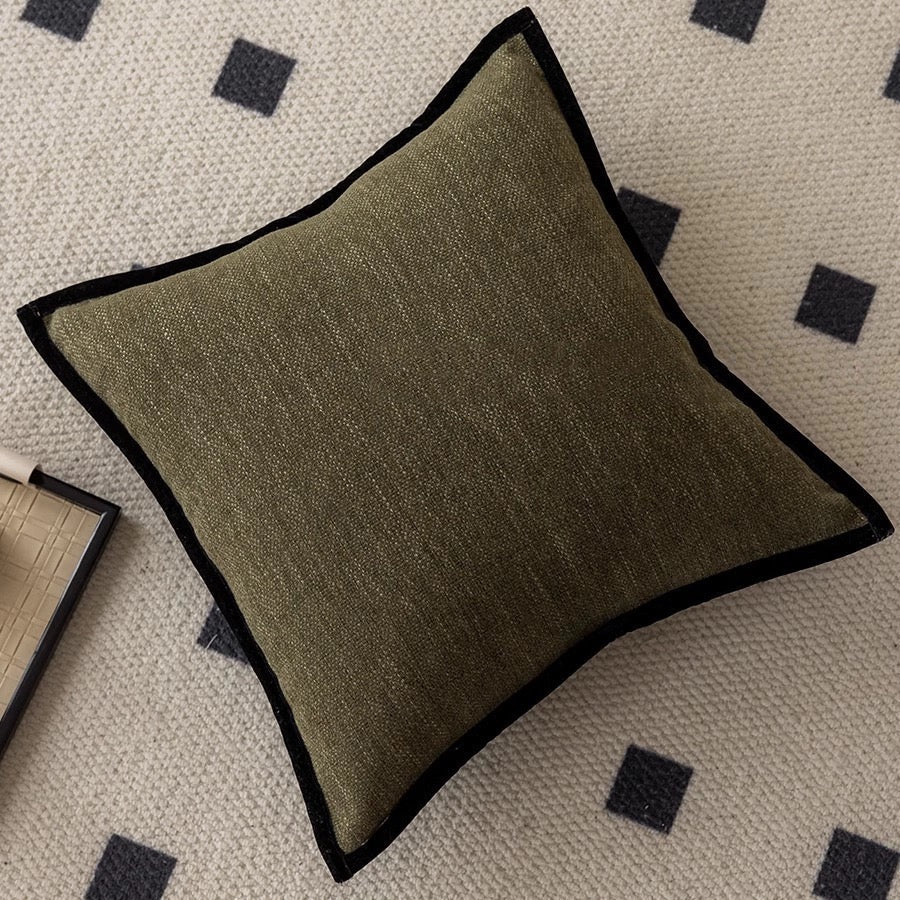 Brown textured pillow on a patterned rug