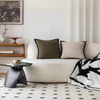 Modern living room with a white sofa, decorative pillows, and a coffee table.