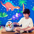 A young boy sits on a rug next to a dinosaur-themed light-up egg toy, pointing at it. The egg is decorated with various colorful dinosaur illustrations.