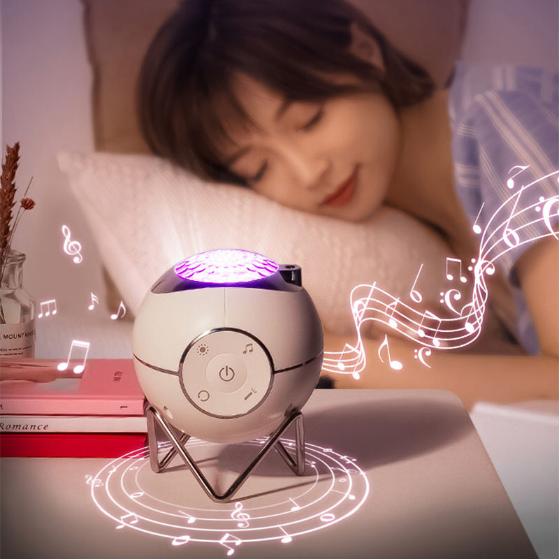 White and purple device emitting music notes on a table with a person lying in bed in the background