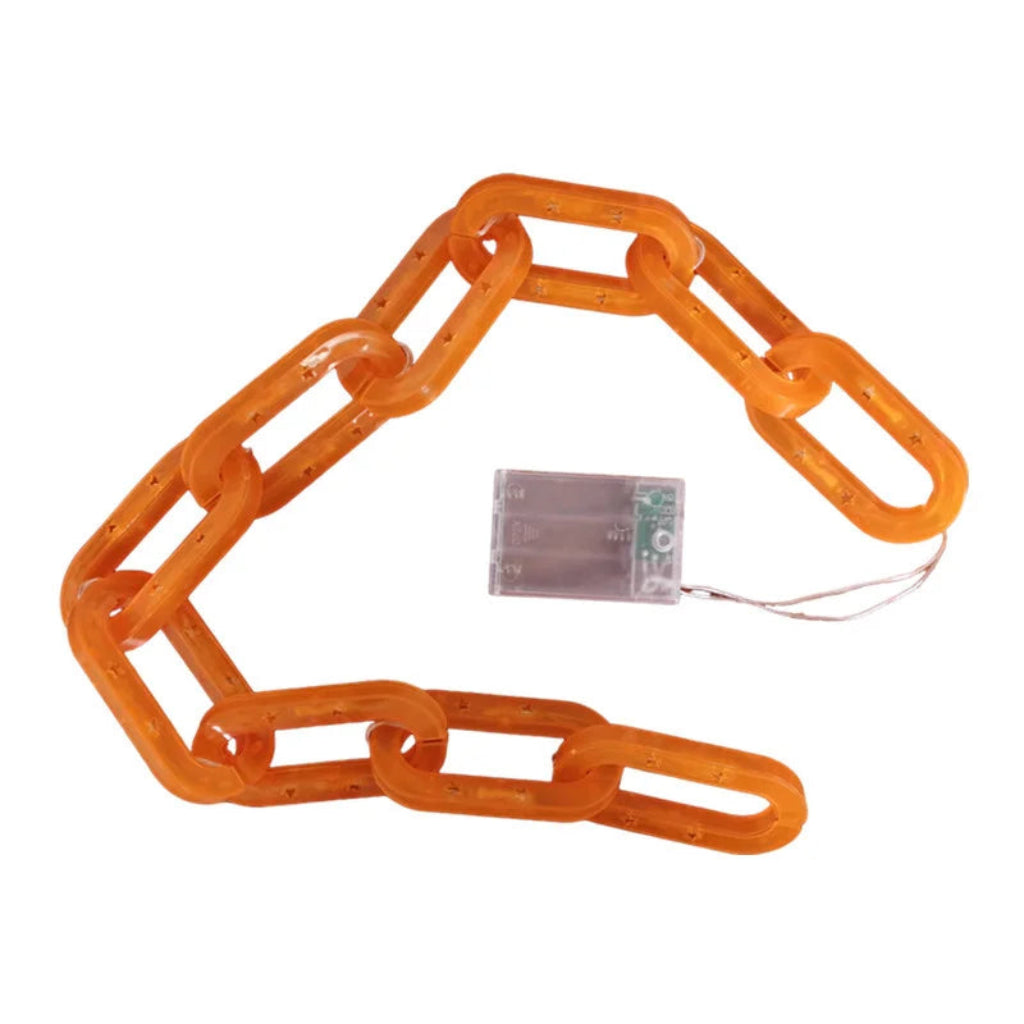 An orange translucent plastic link chain arranged in a circle on a white background, with a small clear battery pack and wire connector in the center.