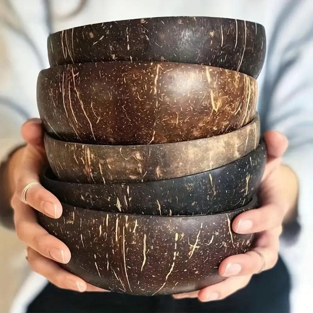 Stack of coconut shell bowls held by a person