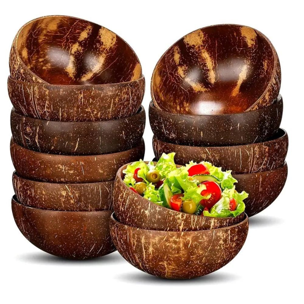 Set of coconut bowls with a bowl of salad on a white background