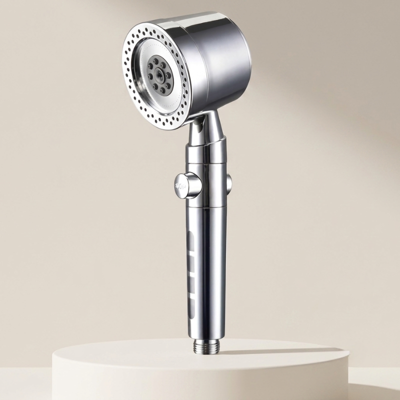 Chrome handheld shower head on a beige background