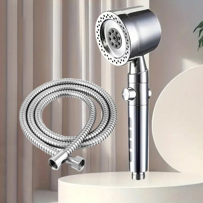 Chrome handheld shower head with flexible hose on a neutral background