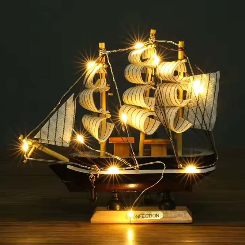 Model ship with lights on a dark background