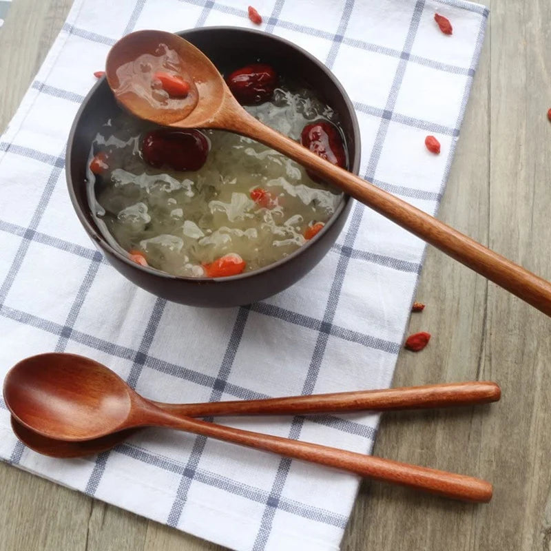 Bowl of soup with wooden spoons on a checkered cloth