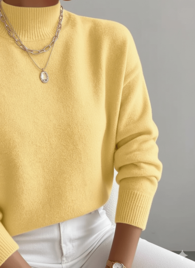 Yellow sweater worn by a person with a neutral background