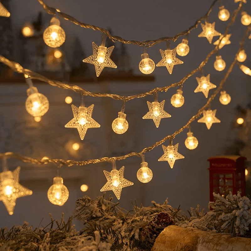 String lights with star and bulb decorations on a festive background
