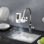 Modern kitchen sink with faucet and water dispenser against a gray wall.