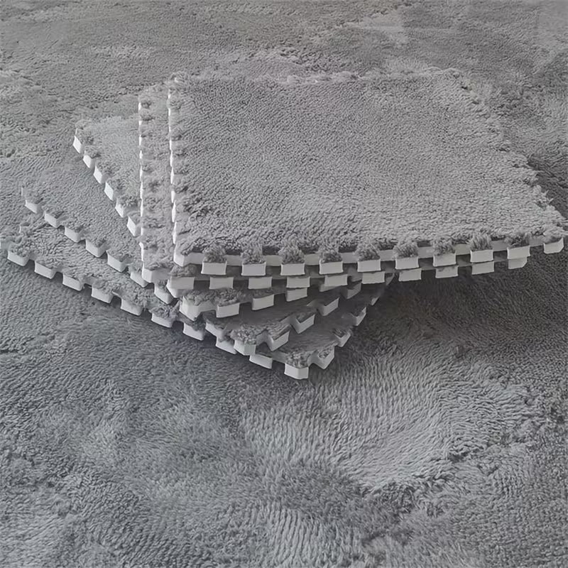 Stack of interlocking foam tiles on a textured surface