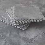 Stack of interlocking foam tiles on a textured surface