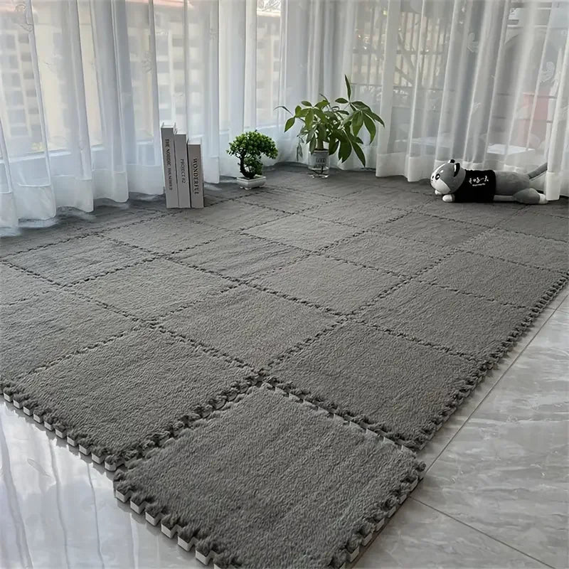 Gray interlocking foam mats on a floor with white curtains in the background
