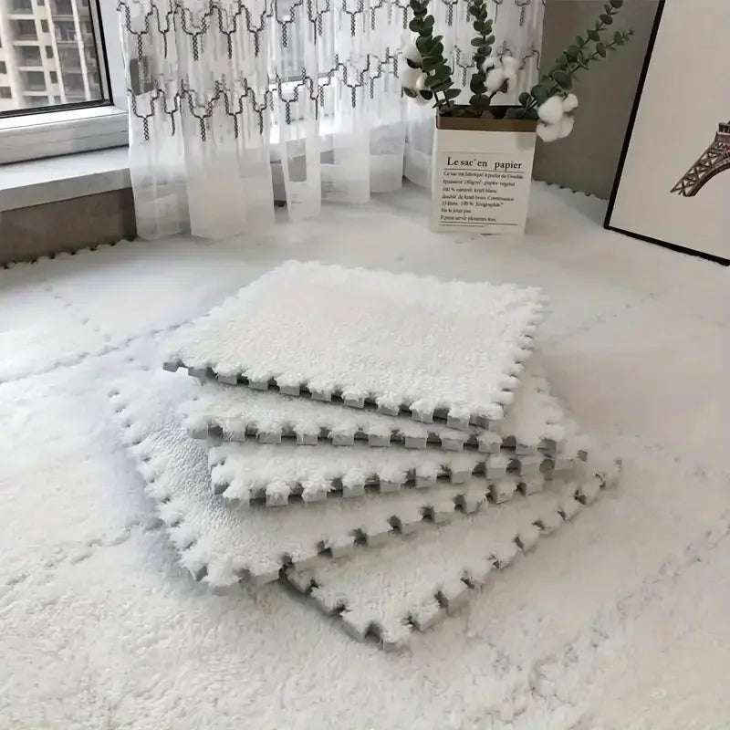 Stack of white foam mats on a light-colored floor with a decorative plant in the background.