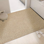 Beige rug on a light wooden floor with a chair and white shoes in the foreground.